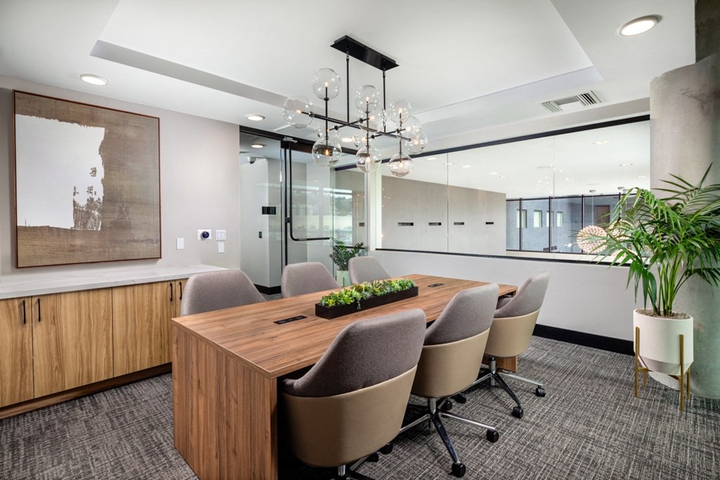 a conference room with a long wooden table and gray chairs at VORA LUX, California
