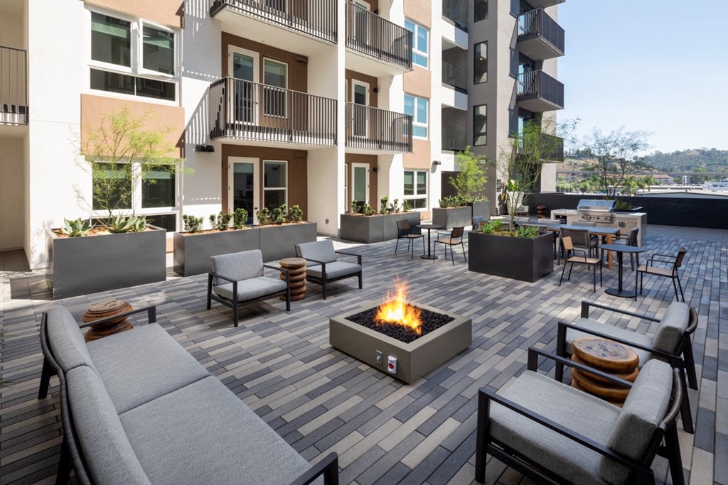 an outdoor patio with a fire pit and seating at VORA LUX, San Diego, CA 92120