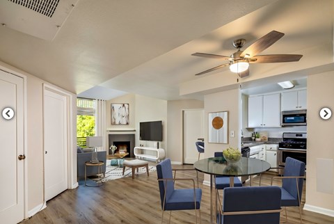 A modern open plan living and dining area with a fireplace.