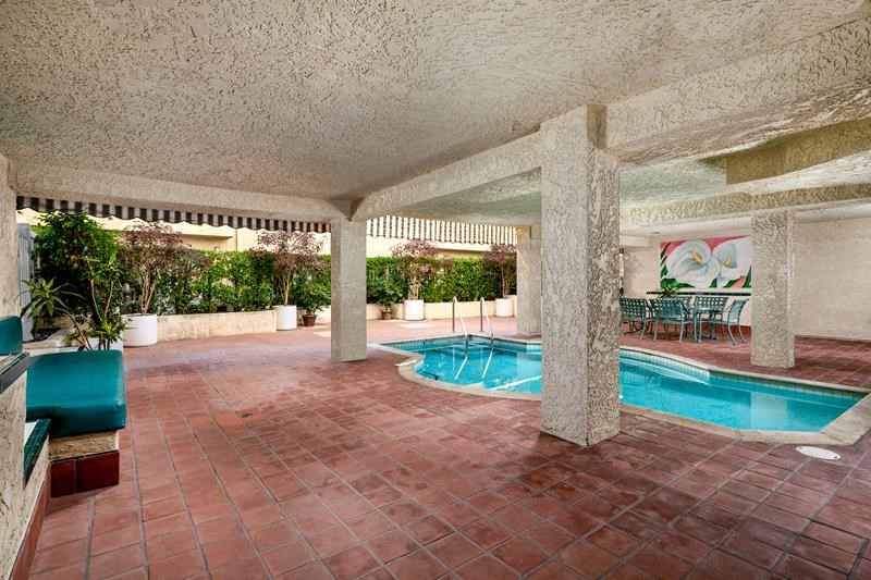 a swimming pool in the middle of a room with columns