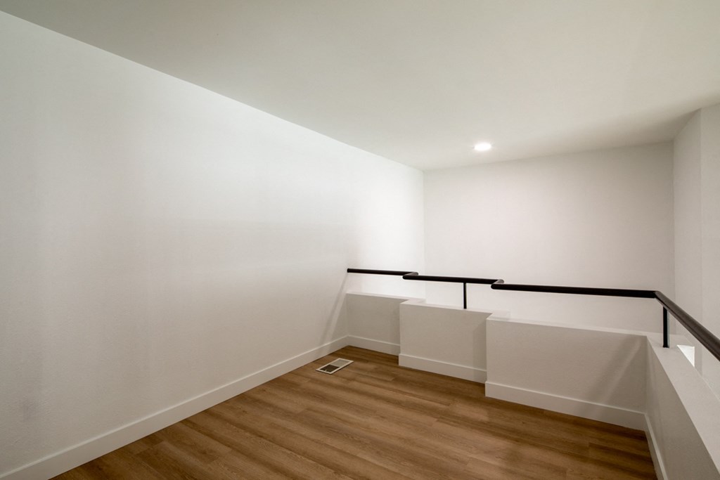 A room with wooden floors and white walls.