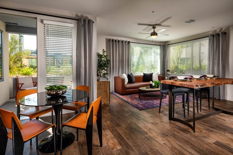 A modern dining room with a glass table and chairs.