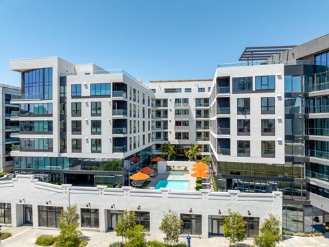 an aerial view of an apartment building with a swimming pool