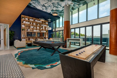 a game room with a foosball table and a pool table