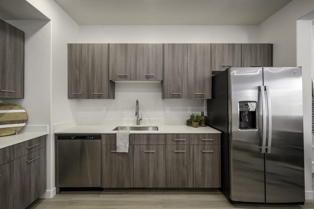 a kitchen with stainless steel appliances and wooden cabinets