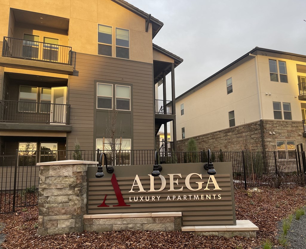 an adega luxury apartments sign in front of an apartment building