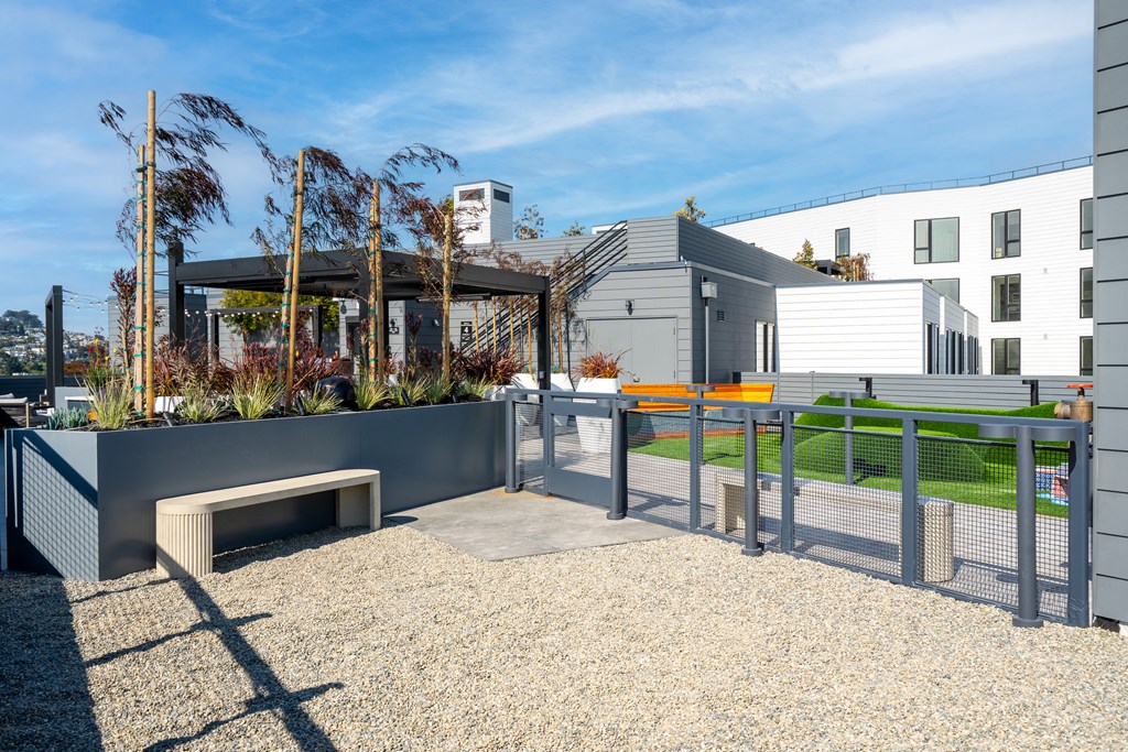 a ramp with a bench and a fence in front of a building