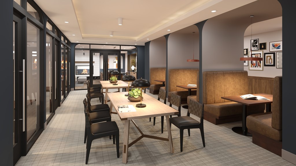 A long table with chairs is in the middle of a room.