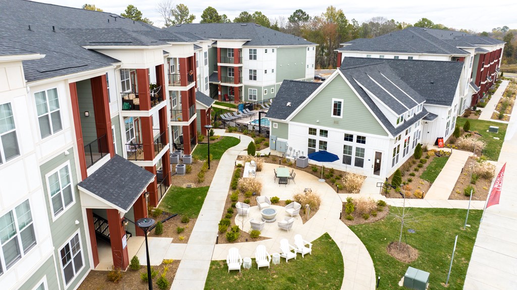 an aerial view of a group of houses with tables and chairs