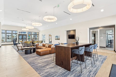 A modern living room with a wooden dining table and blue chairs.