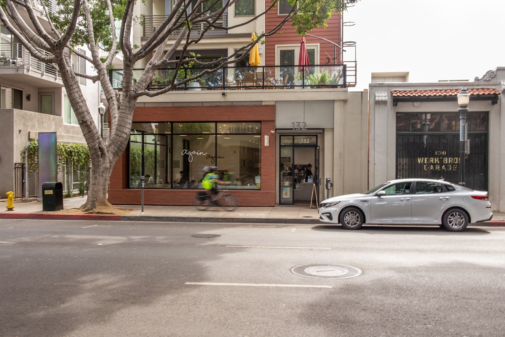 a car parked on the side of the road in front of a building