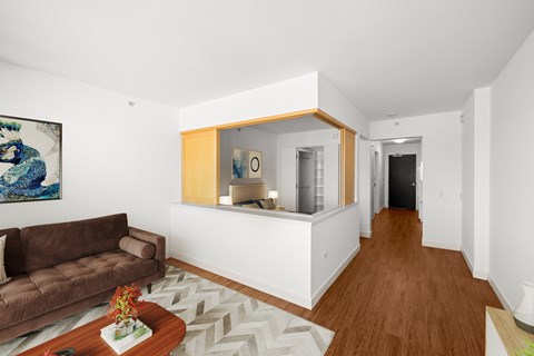 A living room with a brown couch and a coffee table.