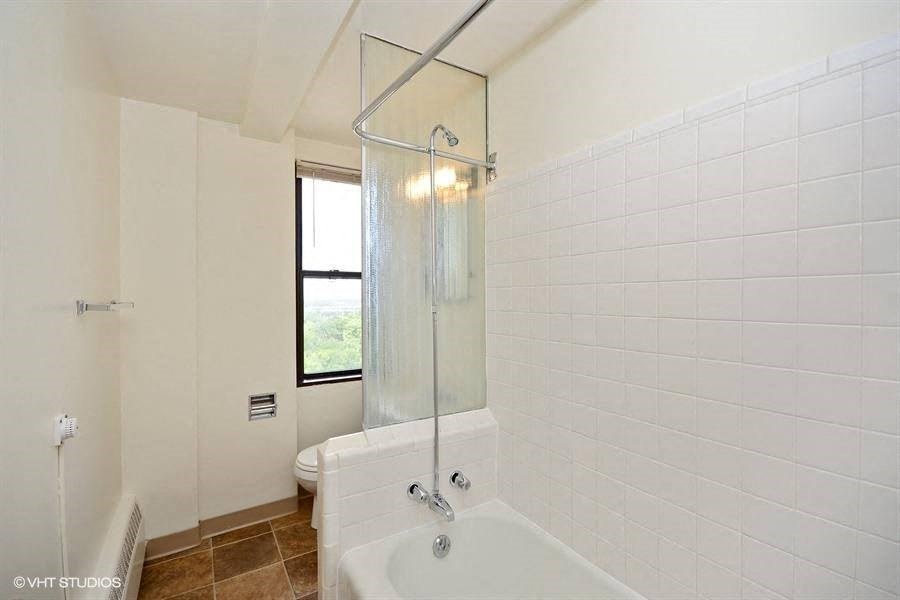 a white bath tub sitting next to a window