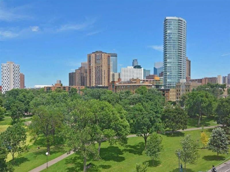 a cityscape with a park in the foreground