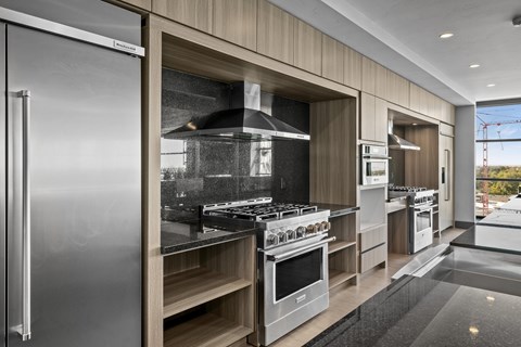 A modern kitchen with stainless steel appliances and wooden accents.