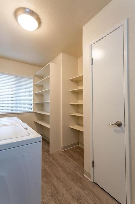 a white closet with shelves and a white door