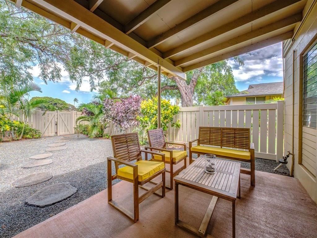 a covered patio with a table and chairs