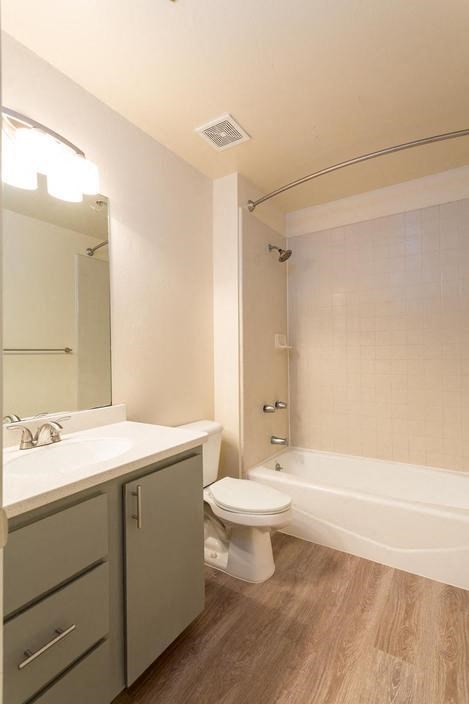 a bathroom with a toilet and a sink and a bath tub