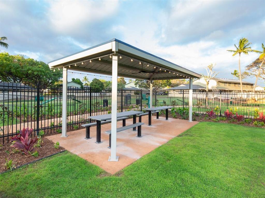 a picnic area with benches in a park
