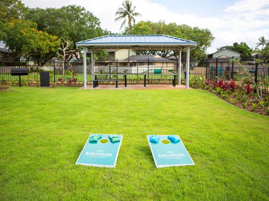 two bean bags on the grass in front of a park