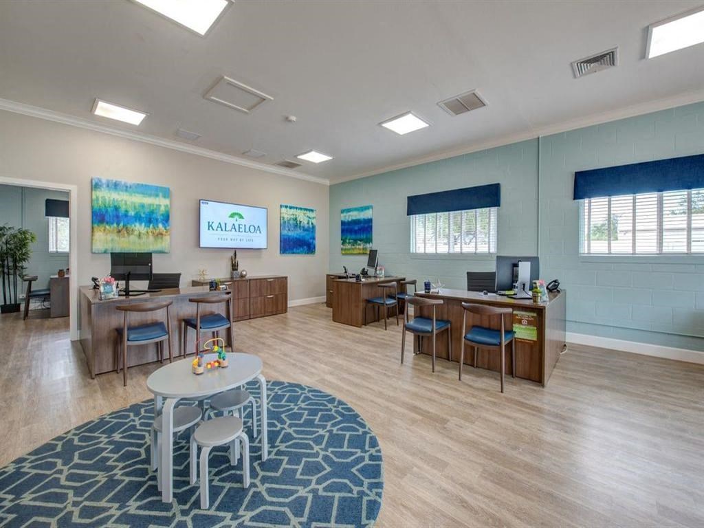 a common room with desks and chairs and a table