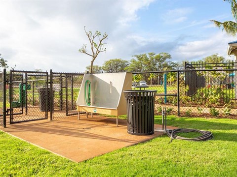 a hot tub in a park next to a trash can