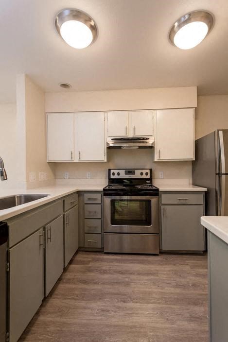 a kitchen with stainless steel appliances and white cabinets