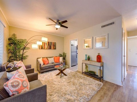 a living room with furniture and a ceiling fan