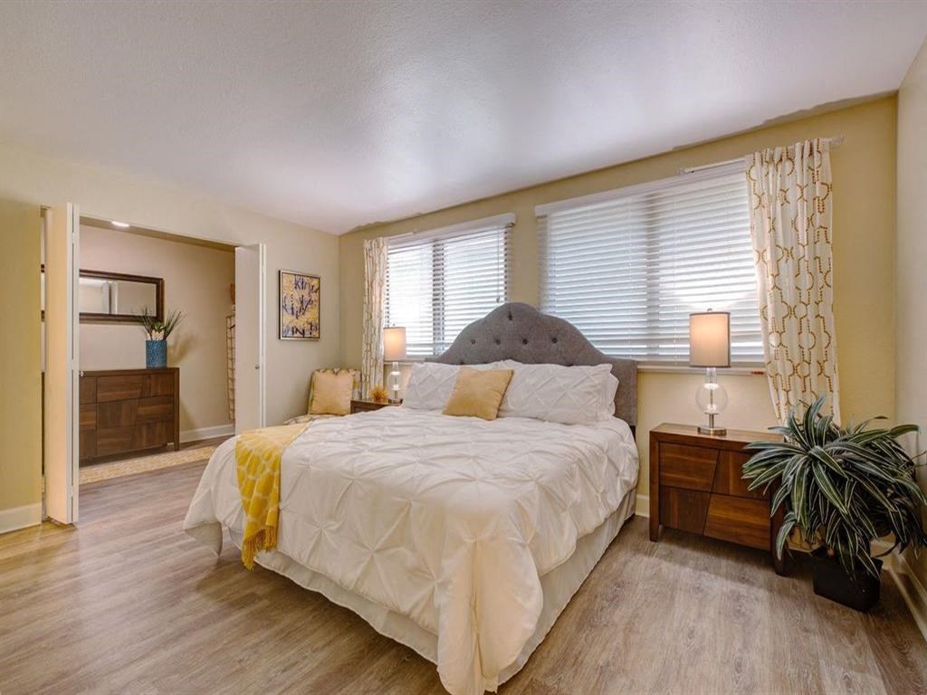 a bedroom with a large bed and a window