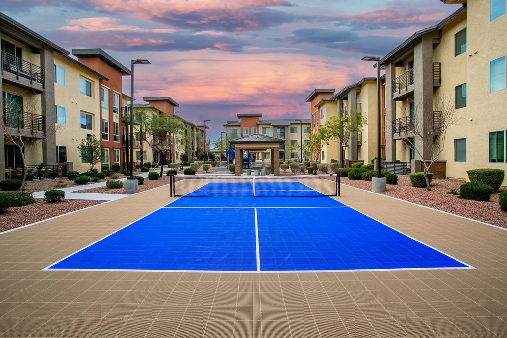 a pickleball court in the middle of an apartment complex