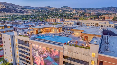 A large building with a pool and a mural on the side.