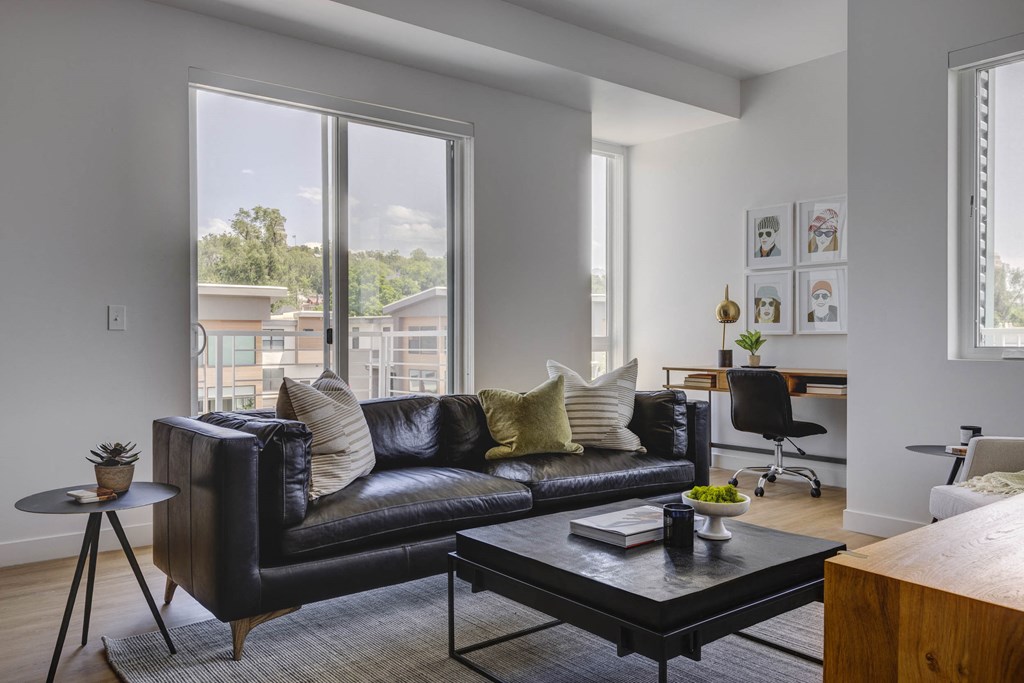 Living room with leather sofa and nook for work space desk at Harvest, Salt Lake City, Utah