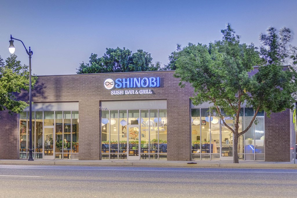 a large brick building with a sign that reads shibuya sashimi grill grill