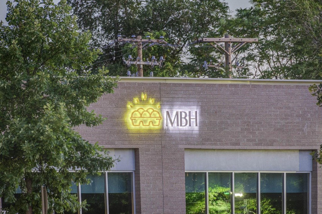 a building with the mbh logo on the front of it