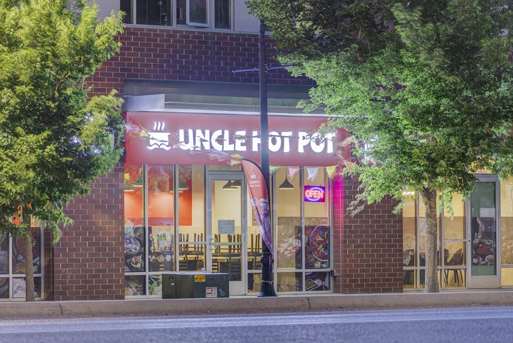 a restaurant with a red sign on the front of it