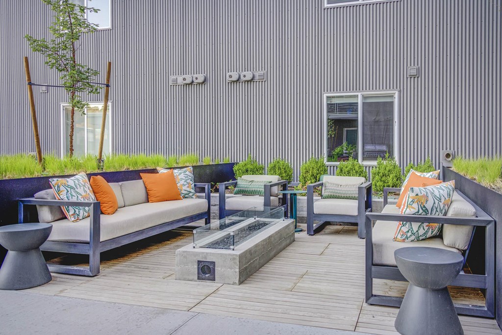 a seating area with couches and chairs on a patio