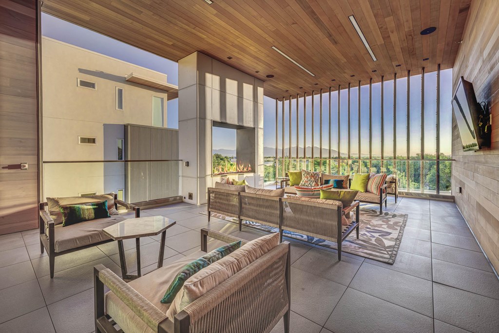 a living room filled with furniture and a large window