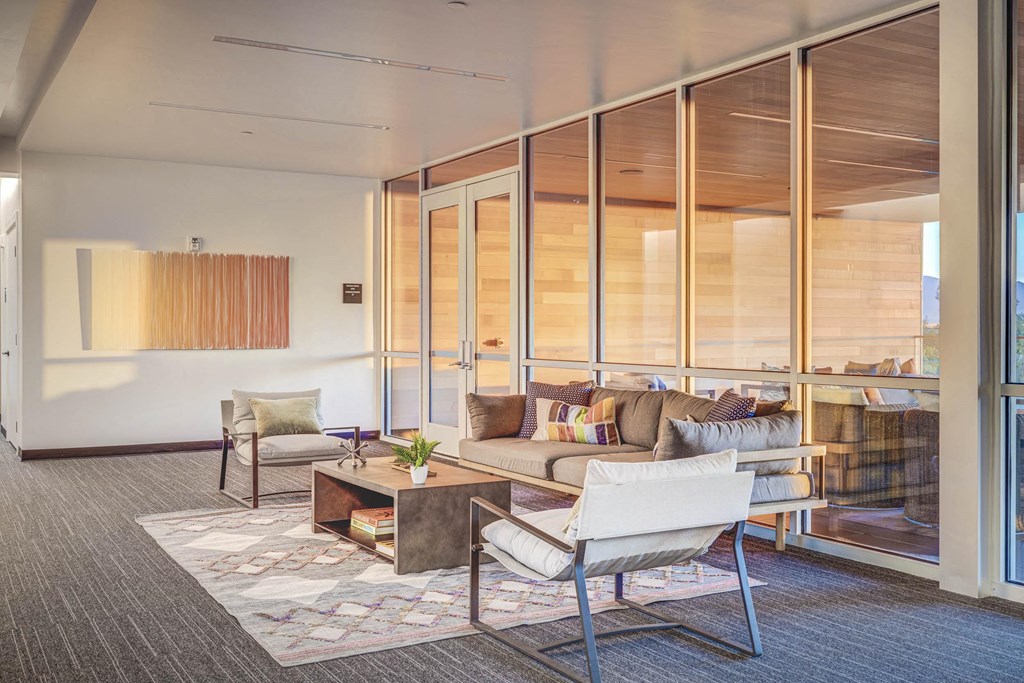 a living room filled with furniture and a large window