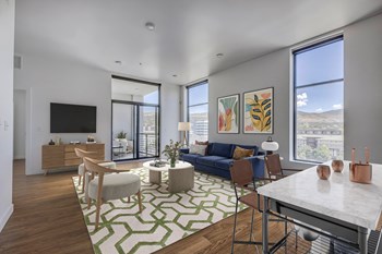 Furnished living room with large windows and wood floors - Photo Gallery 3