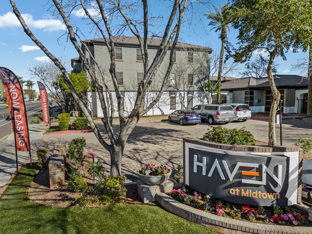 a building with a sign in front of a parking lot
