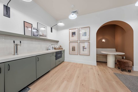 A kitchen with wooden floors and a white counter top.