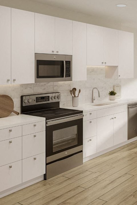 a white kitchen with a stove and a microwave