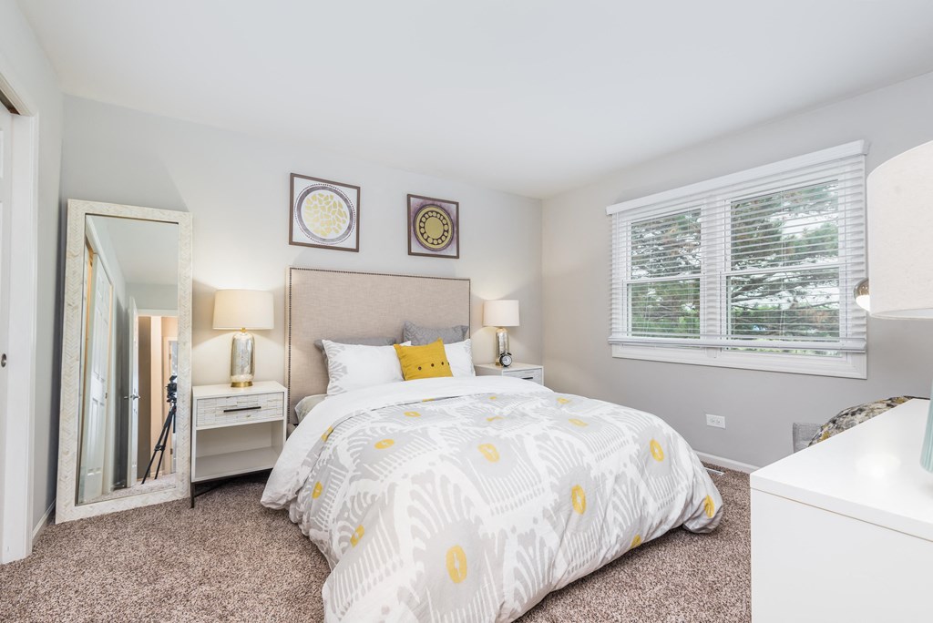 a bedroom with a large bed and a mirror