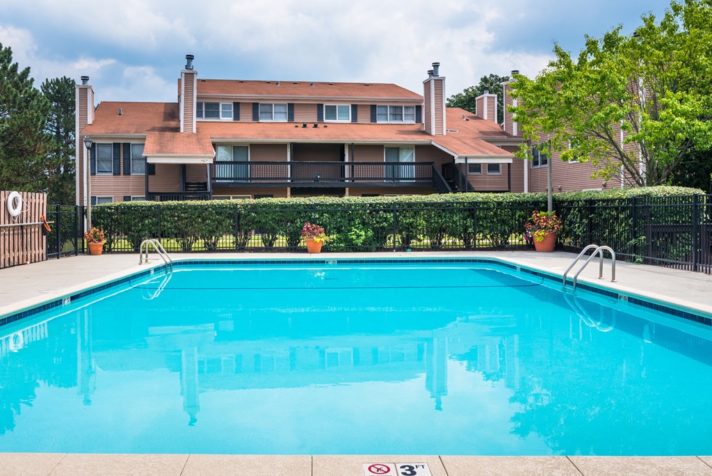 a large swimming pool with a building in the background