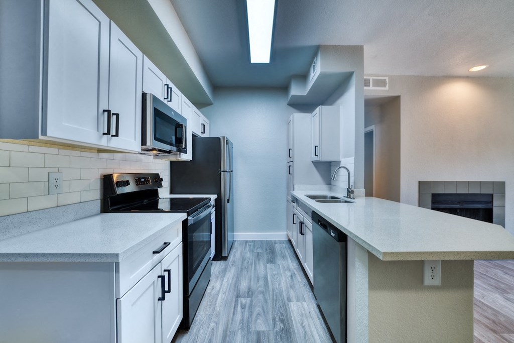 a kitchen with white cabinets and a black stove top oven