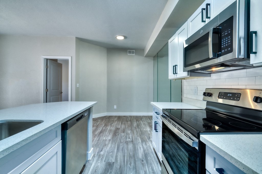 a kitchen with white cabinets and a black stove top oven
