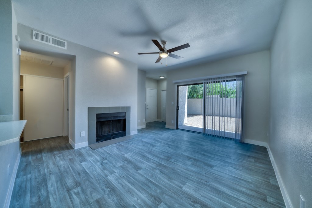 a living room with a fireplace and a sliding glass door