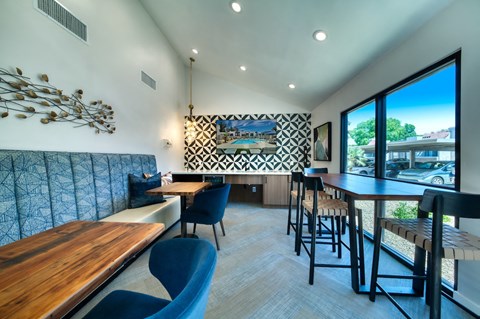 a dining area with tables and chairs and a large window