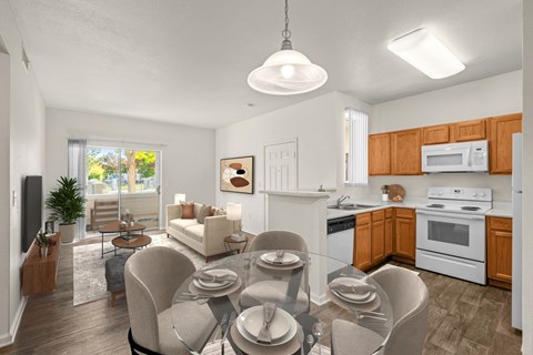 A modern kitchen with a dining table set for four.