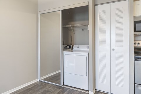 A white kitchen with a dishwasher and a microwave.